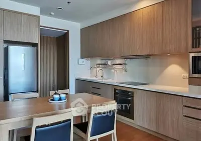 Modern kitchen with sleek wooden cabinetry and integrated appliances