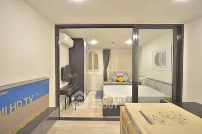 Modern studio apartment with stylish decor and natural lighting, featuring a cozy bedroom and workspace.