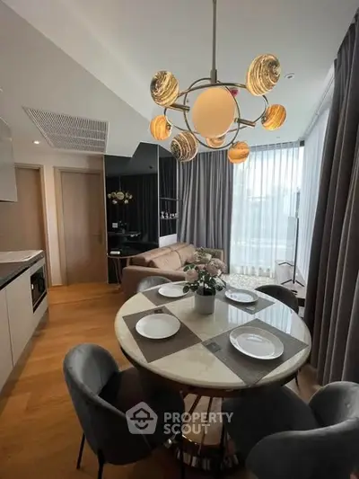 Modern dining area with stylish lighting and cozy seating in a contemporary apartment.