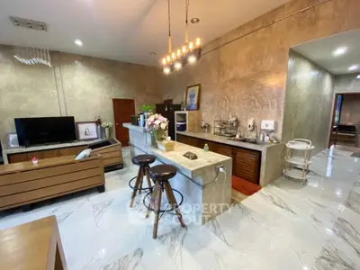 Luxurious open-plan living room with modern kitchen and elegant decor