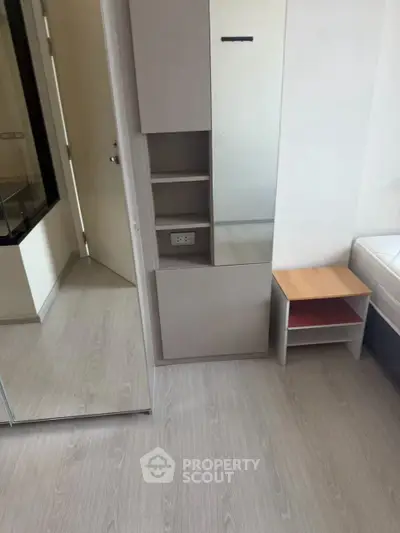 Modern bedroom with sleek flooring and built-in storage, perfect for minimalist living.