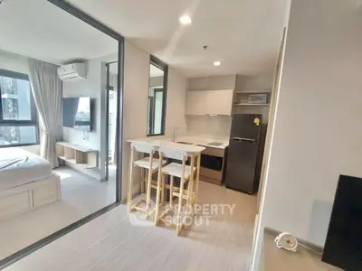 Modern studio apartment with open kitchen and bright bedroom