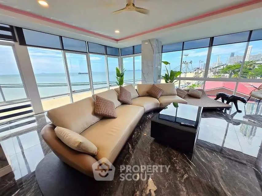 Luxurious living room with panoramic ocean view and modern furnishings.
