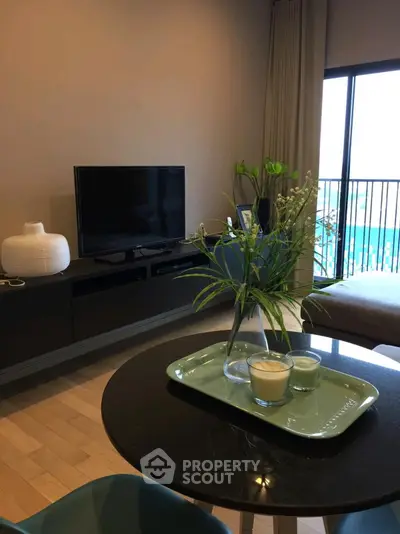 Modern living room with TV, stylish decor, and balcony view