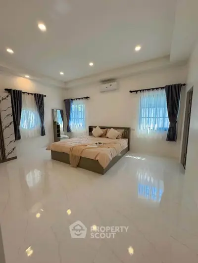 Spacious bedroom with elegant decor and natural light