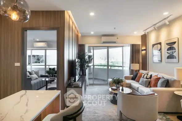 Luxurious modern living room with elegant decor and spacious balcony view.