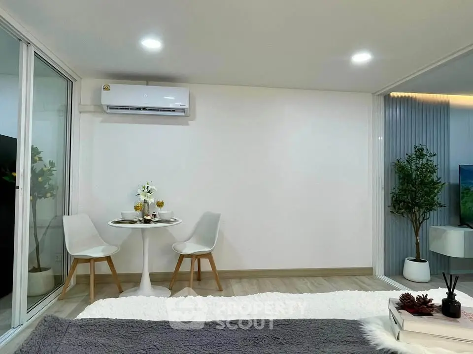 Modern bedroom with cozy dining nook and air conditioning in stylish apartment