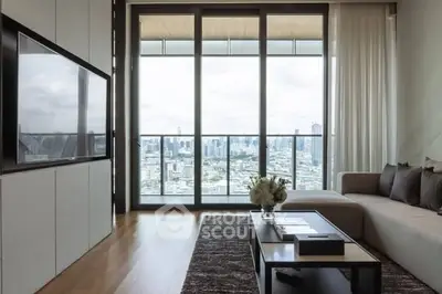 Luxurious living room with stunning city view from floor-to-ceiling windows and modern decor.