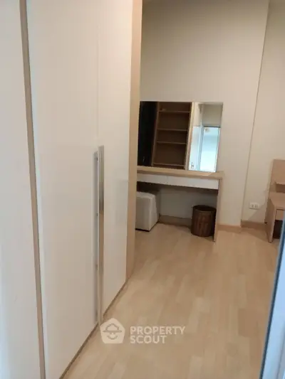 Spacious bedroom with modern wardrobe and vanity in a stylish apartment