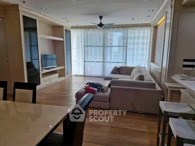 Spacious living room with modern furniture and large windows for natural light.