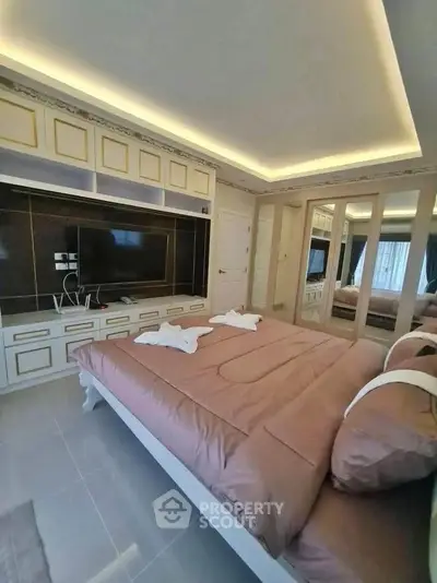 Luxurious bedroom with elegant design, featuring built-in storage and ambient lighting.