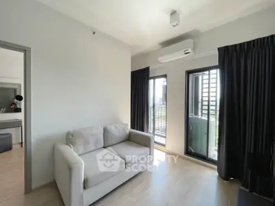 Modern living room with balcony access and natural light