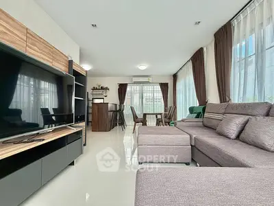 Spacious modern living room with large windows and stylish furniture