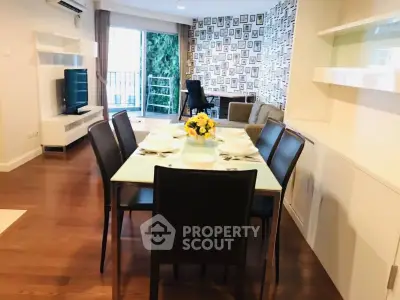 Modern dining area with elegant table setting and cozy living room view.