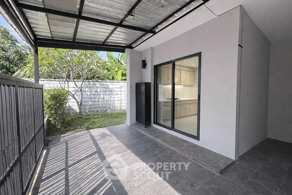 Modern patio with sliding glass doors and garden view