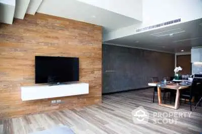 Modern living room with wooden accent wall and sleek dining area