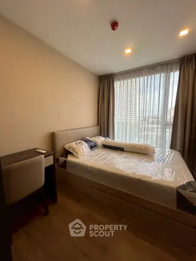 Cozy bedroom with modern furnishings and large window view