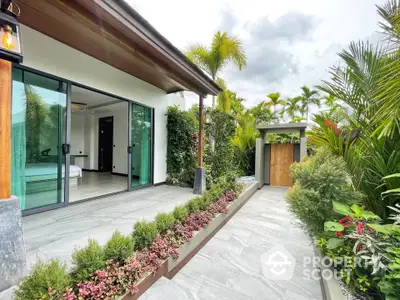 Luxurious tropical garden entrance with modern glass doors and lush greenery