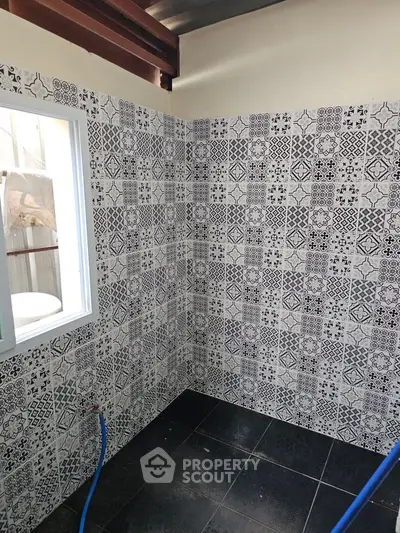 Stylish bathroom with patterned tiles and modern window design