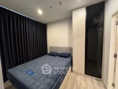 Modern bedroom with sleek design and cozy atmosphere, featuring a stylish bed and wardrobe.