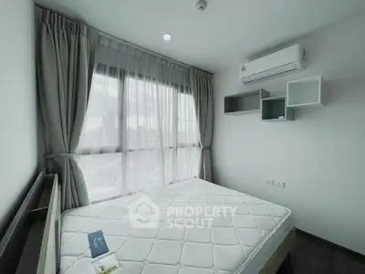Modern bedroom with large window and air conditioning in high-rise apartment.