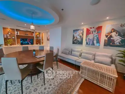 Luxurious living room with modern decor, elegant dining area, and artistic wall paintings.