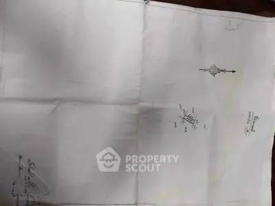 Architectural blueprint with compass and annotations, showcasing property layout and design details.