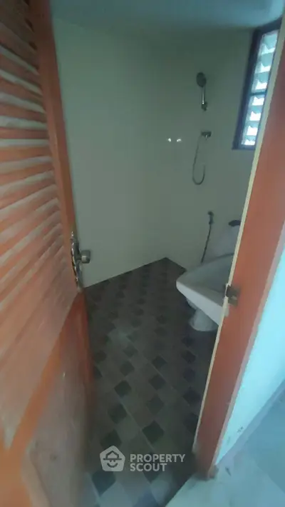 Cozy bathroom with modern shower and tiled flooring, perfect for a compact living space.