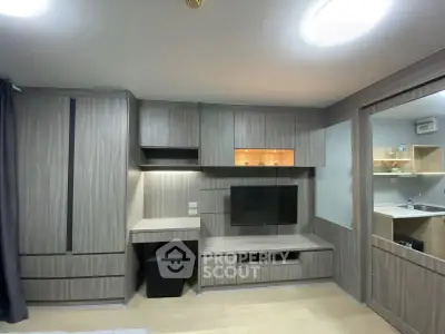 Modern living room with built-in wooden cabinets and TV setup