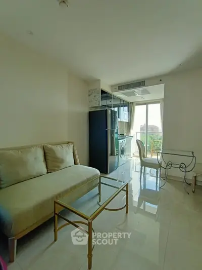 Modern living room with elegant furniture and balcony view in a bright apartment.