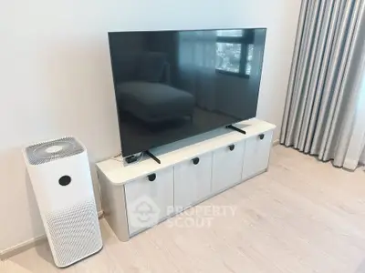 Modern living room with sleek TV setup and air purifier, perfect for contemporary living.