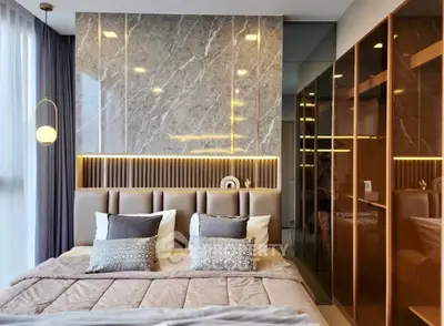 Luxurious modern bedroom with elegant marble accent wall and plush bedding