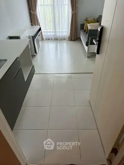 Modern compact living room with natural light and sleek furnishings