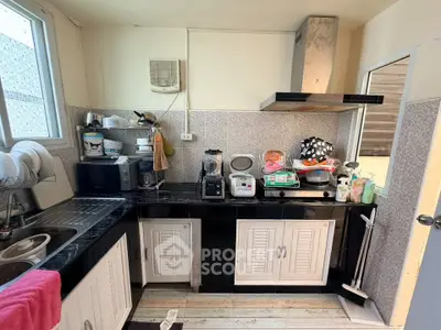 Charming kitchen with modern appliances and ample storage in a cozy home setting.