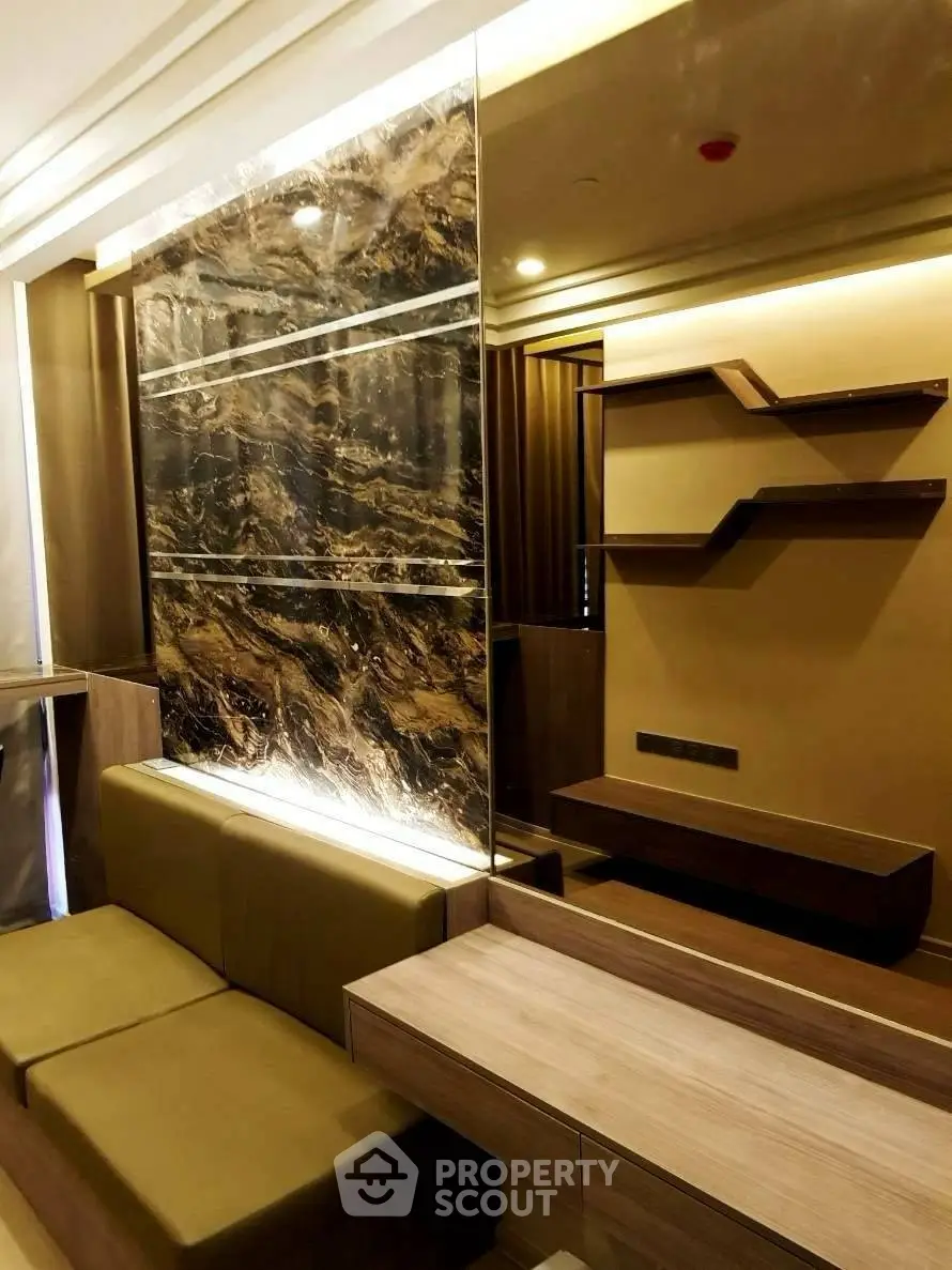 Luxurious modern living room with elegant marble accent wall and stylish shelving.