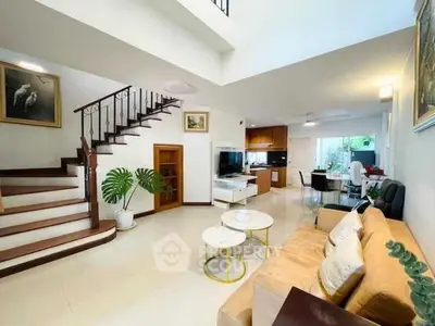 Spacious open-plan living room with elegant staircase and modern decor