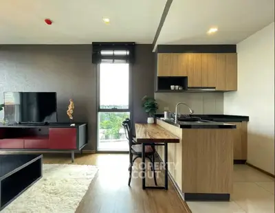 Modern open-layout living room with stylish kitchen and natural light