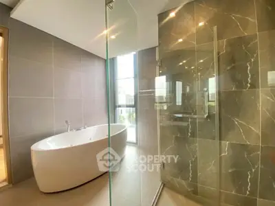 Luxurious modern bathroom with elegant bathtub and glass shower enclosure