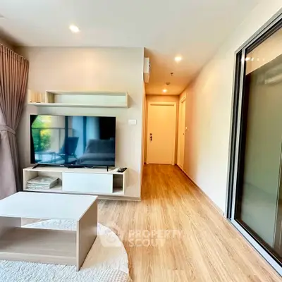 Modern living room with sleek TV unit and wooden flooring