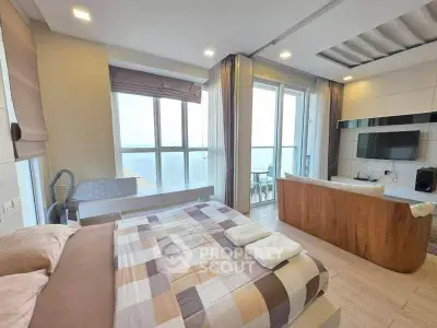 Luxurious bedroom with ocean view and stylish living area in modern apartment