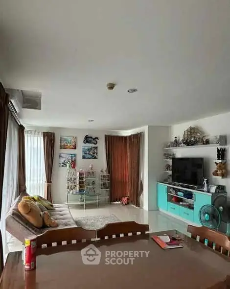 Spacious living room with modern decor and ample natural light