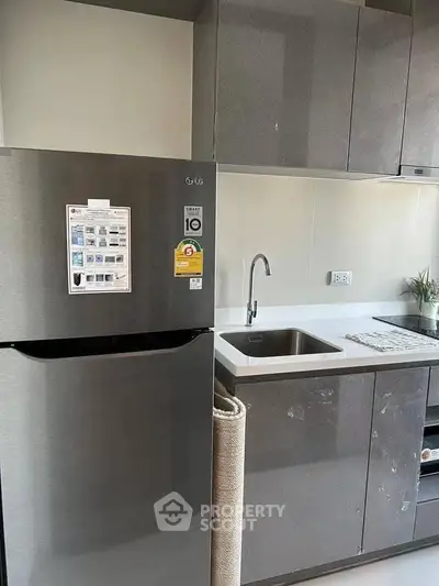 Modern kitchen with sleek cabinets and stainless steel fridge