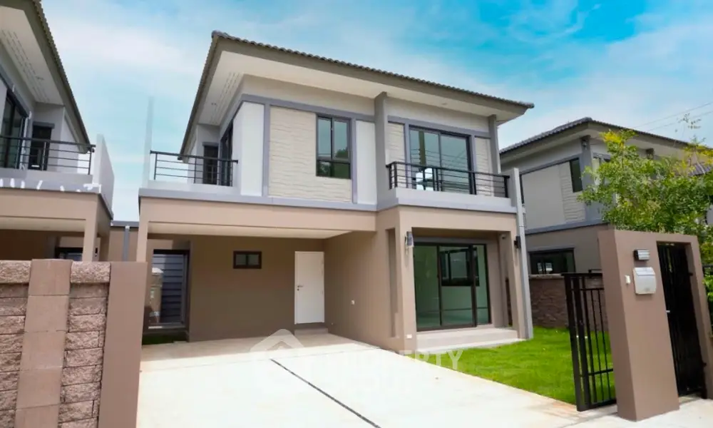 Modern two-story house with driveway and lush green lawn