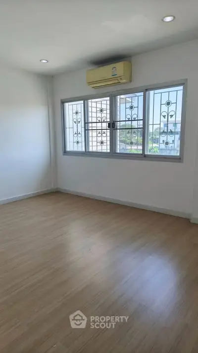 Bright and airy room with large window and air conditioning, perfect for a cozy living space.