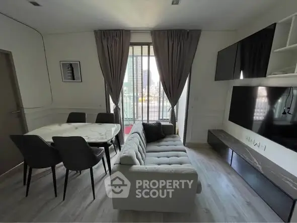 Modern living room with stylish furniture and city view, perfect for urban living.