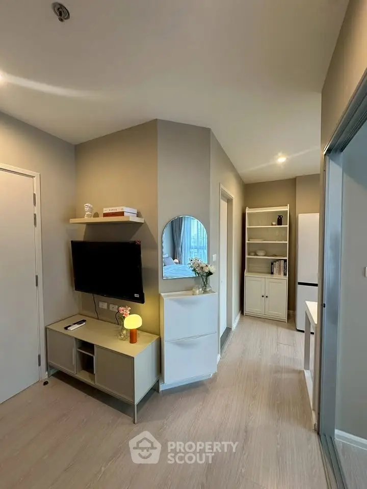 Modern apartment hallway with stylish decor and built-in storage solutions.