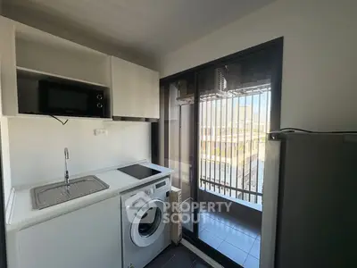 Modern kitchen with sleek appliances and ample natural light, perfect for culinary enthusiasts.