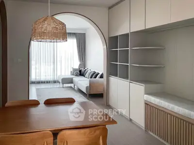 Modern open-plan living room with stylish dining area and cozy seating.