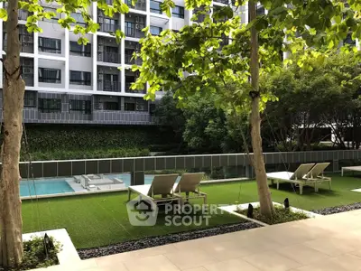 Luxurious apartment complex with serene poolside and lush greenery, perfect for relaxation and leisure.