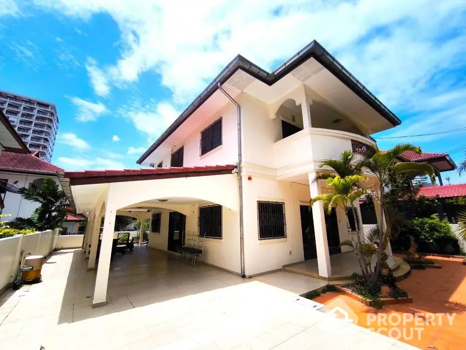 Spacious two-story house with large patio and tropical garden